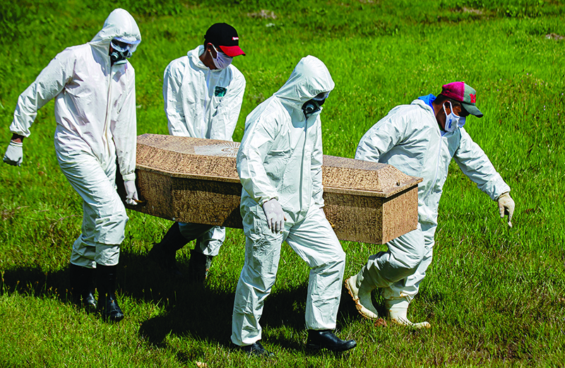 PARA STATE: Cemetery workers wear protective suits as they carry out the burial of Edivaldo da Silva, who died at the age of 77 from COVID-19, at the Recanto da Peace Municipal Cemetery in Breves, Para state, Brazil. —AFP