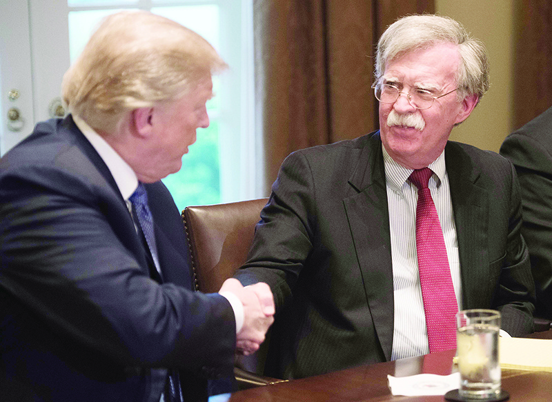 WASHINGTON: In this file photo taken on April 9, 2018, US President Donald Trump shakes hands with National Security Advisor John Bolton during a meeting with senior military leaders at the White House. — AFP