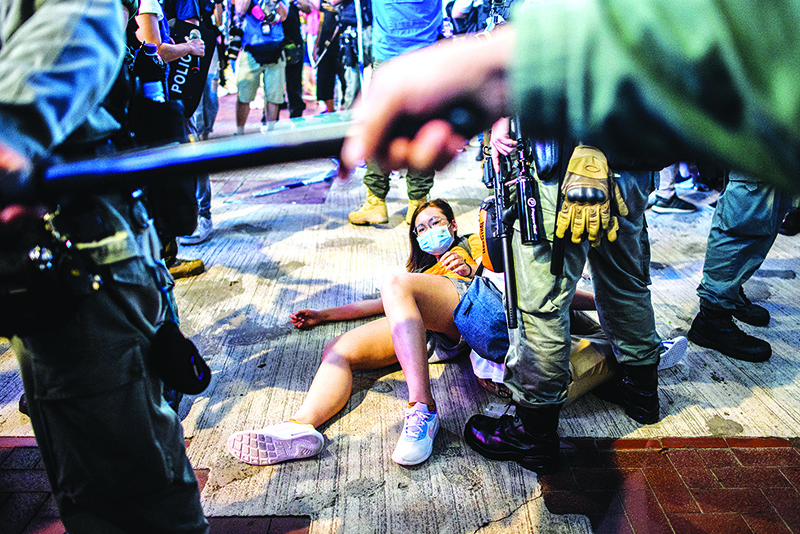HONG KONG:  People are detained as pro-democracy protesters gather in the Causeway Bay district of Hong Kong. — AFP