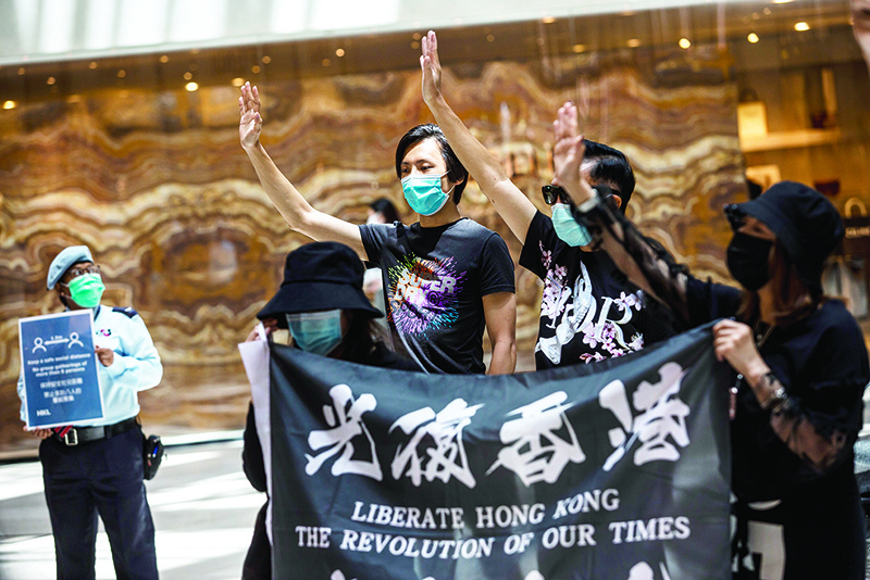 HONG KONG: Pro-democracy protesters gather during a ‘Lunch With You’ rally at a shopping mall in the Central district of Hong Kong  yesterday. —AFP