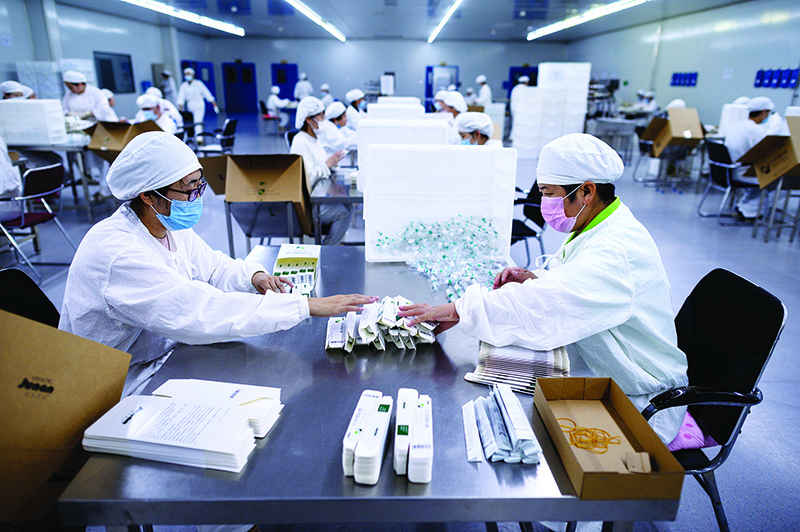 SHENYANG: Workers package rabies vaccine at a lab at the Yisheng Biopharma company, where researchers are trying to develop a vaccine for the COVID-19 coronavirus, in Shenyang, in China’s northeast Liaoning province. —AFP