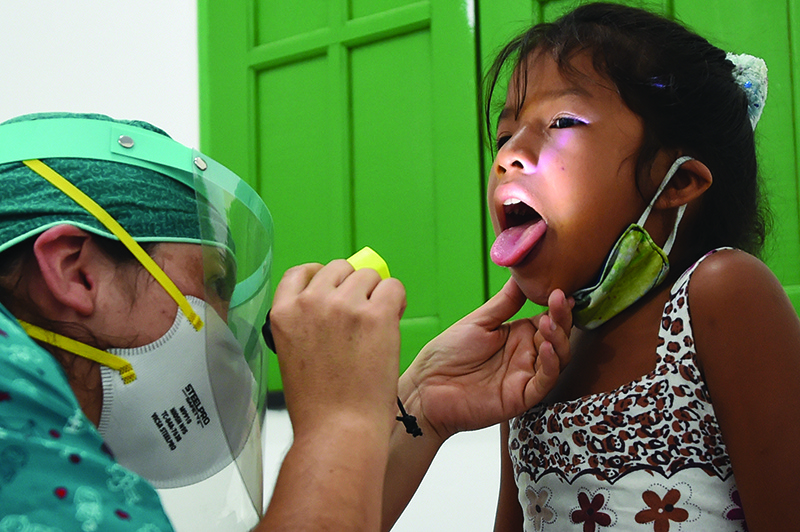 TABATINGA, Brazil: An indigenous girl of the Ticuna ethnic group receives medical assistance at a health post in Umariacu village in Amazonas state on Friday amid the coronavirus pandemic. — AFP