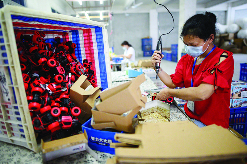 SHANTOU: A worker assembles toy cars at the Mendiss toy factory in Shantou, southern China’s Guangdong province. Cancelled shipments, returned goods and a dearth of new orders have left China exporters in crisis as the coronavirus hits its trading partners worldwide — accelerating a long-standing push towards domestic consumption. — FP