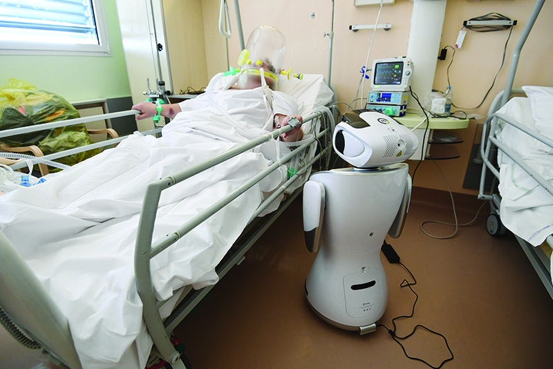 ROME: One of the six robots of the Circolo di Varese hospital stands near a patient, to help the healthcare staff of the High Intensity Medicine department to assist twelve patients suffuring from the epedemic Covid-19. — AFP photos