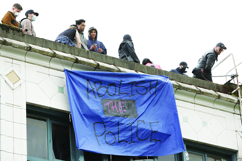 SEATTLE: A banner which reads ‘abolish the police’ hangs from a building in an area being called the Capitol Hill Autonomous Zone (CHAZ) after the Seattle Police Department’s East Precinct was vacated in Seattle, Washington. —AFP