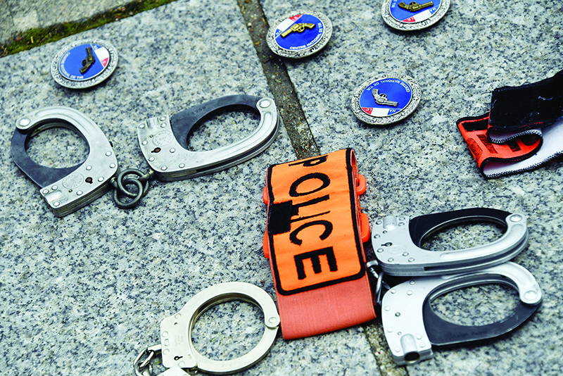 PARIS: Handcuffs and badges are displayed on the ground during a protest in reaction to the French Interior minister’s announcements, amid the latest wave of protests against racism and police violence.  —AFP