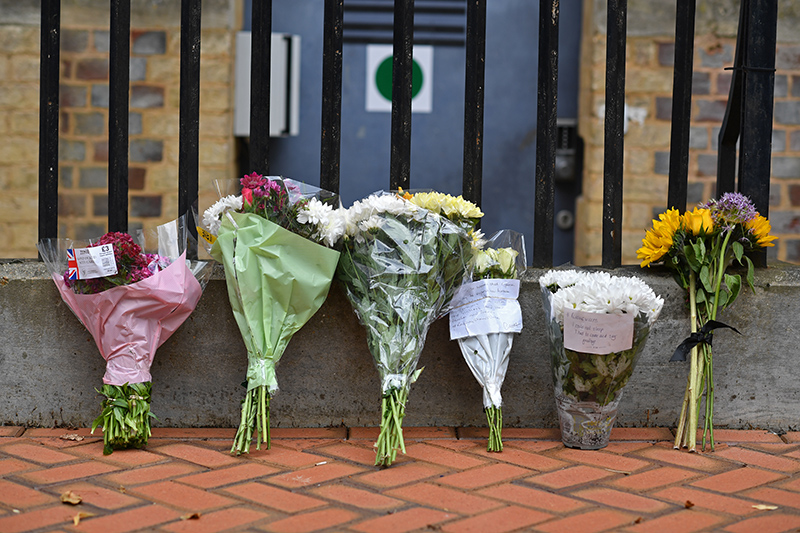 READING: Floral tributes are seen at a police cordon at the Abbey Gateway near Forbury Gardens park in Reading, west of London following a fatal stabbing incident the previous day. —AFP