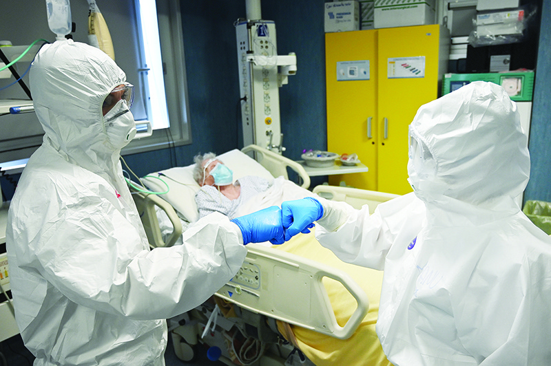 ROME: Doctor Marco (left) and nurse Manu, wearing protective gear, greet as they take care of a patient at the level intensive care unit, treating COVID-19 patients, at the San Filippo Neri hospital in Rome during the country’s lockdown aimed at stopping the spread of the COVID-19 pandemic. — AFP