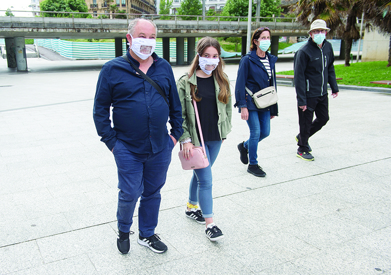 SAN SEBASTIAN: Two people (left) wear a face mask for the hearing-impaired in the Spanish Basque city of San Sebastian. Today, more than 70 percent of Spain’s 47 million population will be in the final stage of the phased rollback that should finish by June 21 in a country badly hit by the epidemic that has killed more than 27,000 people. — AFP