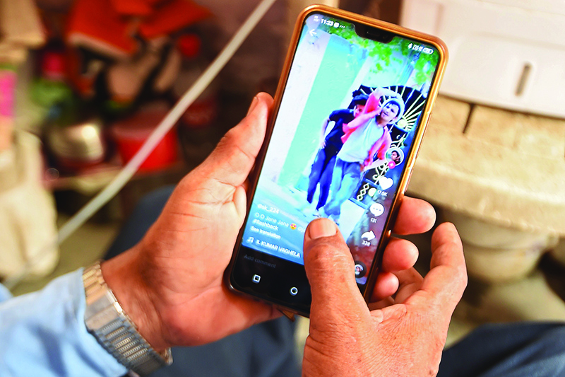 FARIDABAD, India: This photo illustration shows a person using the social media video-sharing app TikTok yesterday. — AFP