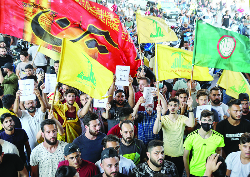 BEIRUT: Supporters of Lebanese Shiite movements Hezbollah and Amal brandish flags and placards as they protest a statement made by the US ambassador at a rally in the southern suburbs of the capital on Sunday. – AFP