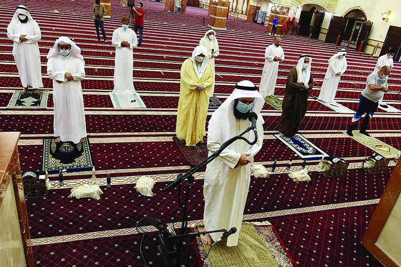 KUWAIT: The imam leads Dhuhr prayers at Bilal Mosque in Siddiq yesterday after some mosques reopened for the first time after three months of closure due to the coronavirus outbreak. — Photo by Yasser Al-Zayyat