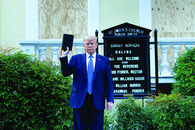 WASHINGTON: US President Donald Trump holds a Bible while visiting St John’s Church across from the White House after the area was cleared of people protesting the death of George Floyd on Monday. — AFP