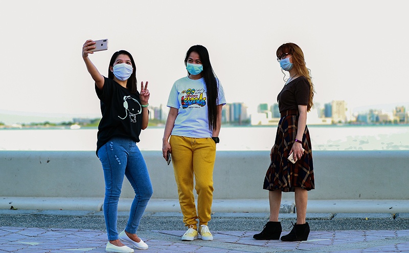 DOHA: Women, wearing masks, pose for a selfie at the waterfront corniche promenade on Monday as Qatar gradually lifts its COVID-19 lockdown. — AFP