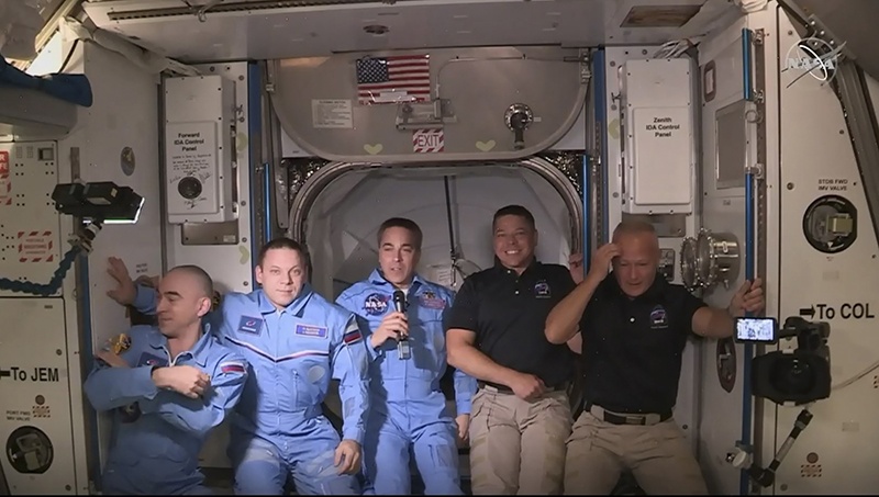 This video frame grab shows NASA SpaceX’s Crew Dragon astronauts Douglas Hurley (right) and Robert Behnken (second right) posing with other astronauts on Sunday after arriving at the International Space Station. – AFP