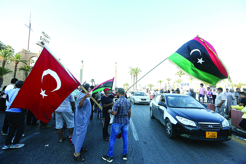 TRIPOLI: People wave flags of Libya and Turkey during a demonstration in Martyrs’ Square in the center of the Libyan capital on Sunday. — AFP