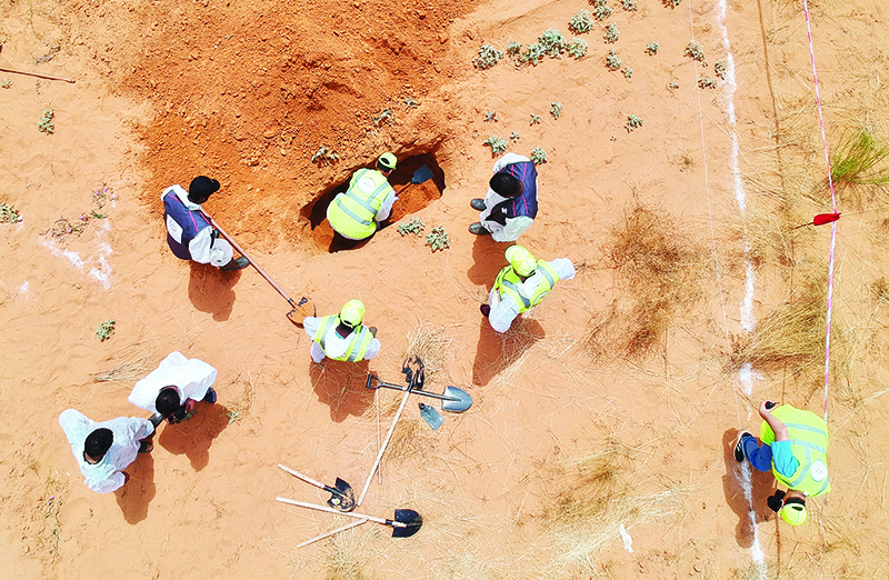 TARHUNA: An aerial view shows Libyan experts searching for human remains during the exhumation of mass graves in Tarhuna, southeast of the capital Tripoli. — AFP
