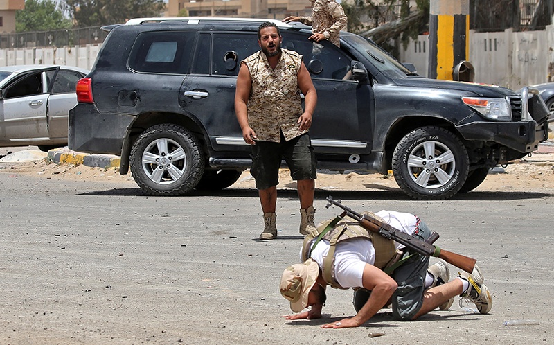 TRIPOLI: A fighter loyal to the UN-recognized Libyan Government of National Accord (GNA) prostrates in prayer as an expression of gratitude as his comrades celebrate in the Qasr bin Ghashir district south of the Libyan capital Tripoli, after the area was taken over by pro-GNA forces following clashes with rival forces loyal to strongman Khalifa Haftar. — AFP