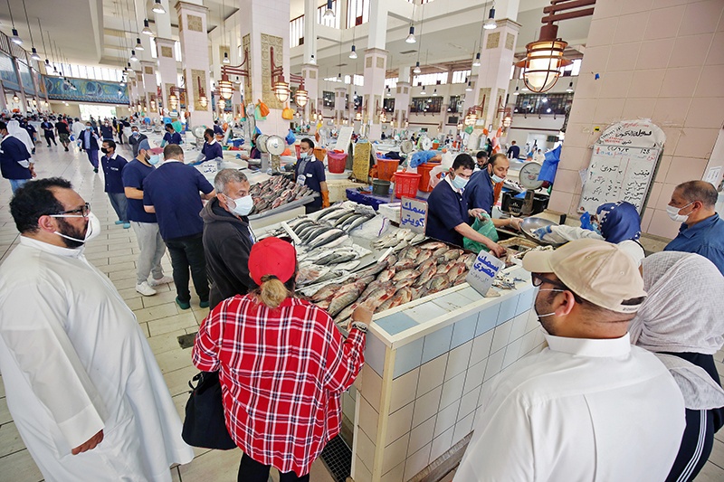 KUWAIT: Mask-clad costumers buy fish at the main fish market in Sharq on June 3, 2020. — Photo by Yasser Al-Zayyat