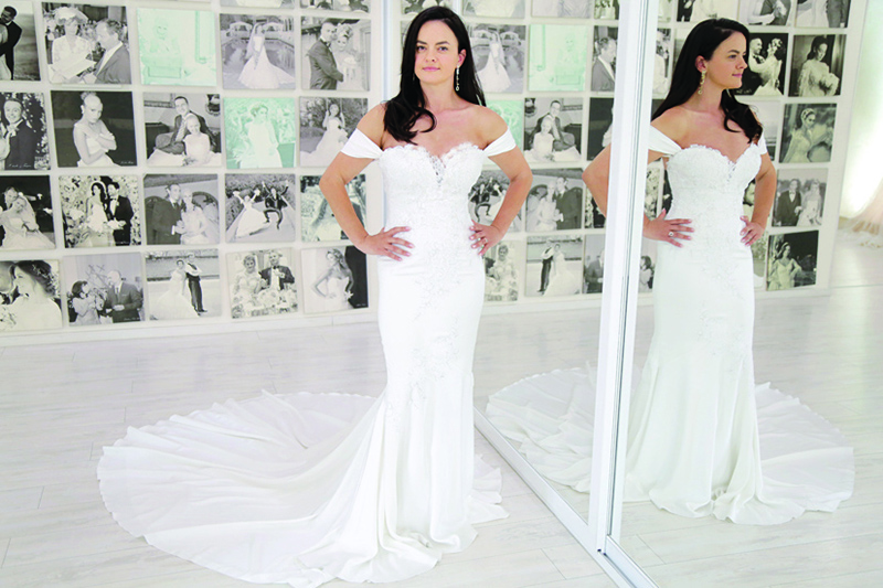 Elona Demollari wears a wedding dress at Geraldina Sposa salon in Tirana.—AFP