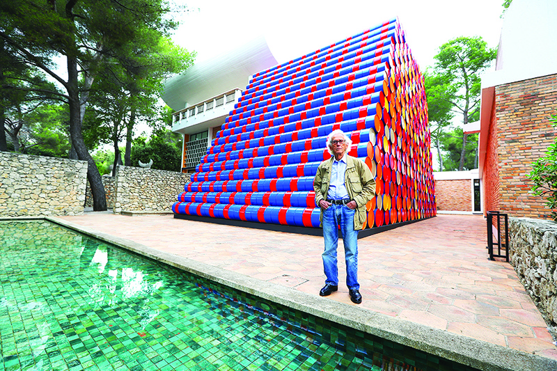 In this file photo taken on June 4, 2016, Bulgarian artist Christo poses in front of the monumental “Mastaba” art work at the Maeght Foundation (Fondation Maeght) on the opening day of the exibition, in Saint-Paul-de-Vence, southeastern France.