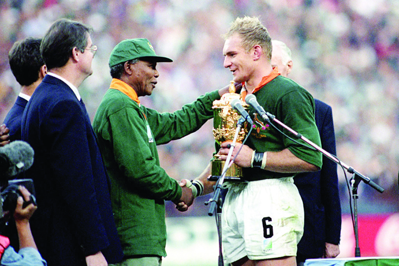 File photo shows South Africa’s rugby captain Francois Pienaar receives the World Cup from President Nelson Mandela.