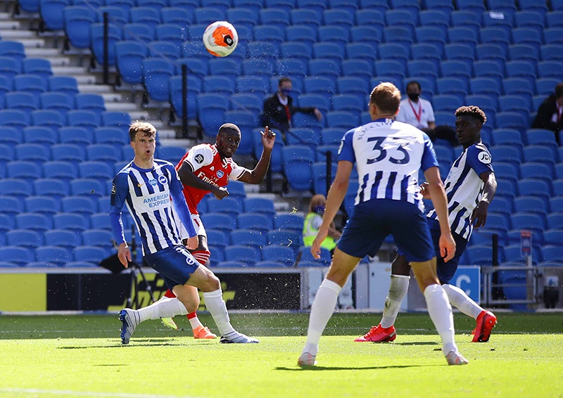 BRIGHTON: Arsenal’s French-born Ivorian midfielder Nicolas Pepe (2L) scores the opening goal during the English Premier League football match between Brighton and Hove Albion and Arsenal at the American Express Community Stadium in Brighton, southern England. —AFP