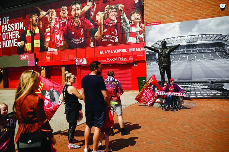LIVERPOOL: Liverpool fans gather in celebration outside Anfield stadium in Liverpool, north west England on June 26, 2020 after Liverpool FC sealed the Premier League title the previous evening. Liverpool were crowned Premier League champions without kicking a ball. — AFP
