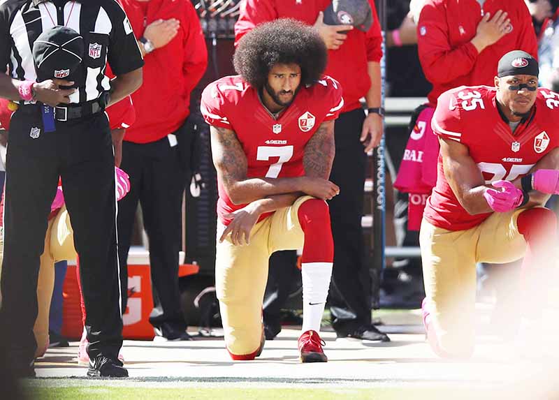 SANTA CLARA: File photo taken on October 23, 2016, Colin Kaepernick (C) and Eric Reid (R) of the San Francisco 49ers kneel in protest during the national anthem prior to their NFL game against the Tampa Bay Buccaneers at Levi’s Stadium in Santa Clara, California. — AFP