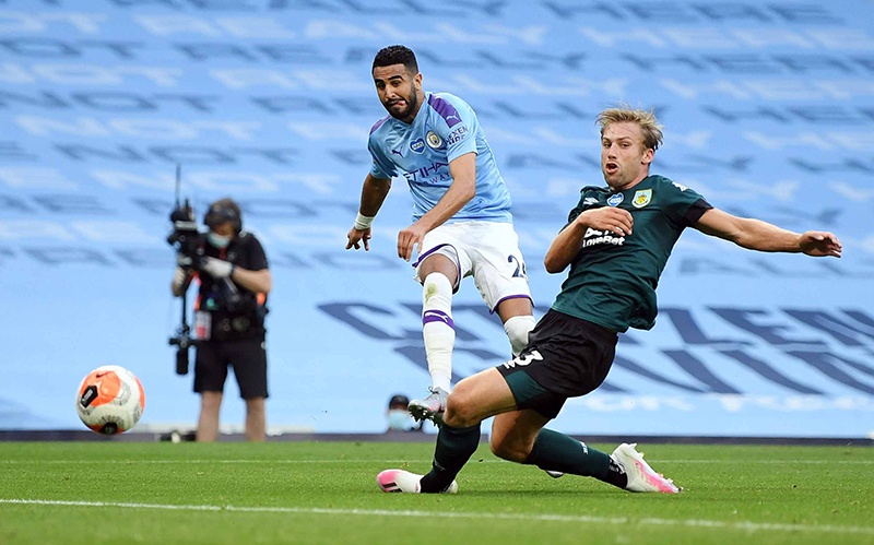 MACHESTER: Manchester City’s Algerian midfielder Riyad Mahrez (L) scores the second goal past Burnley’s English defender Charlie Taylor during the English Premier League football match between Manchester City and Burnley at the Etihad Stadium in Manchester, north west England. — AFP