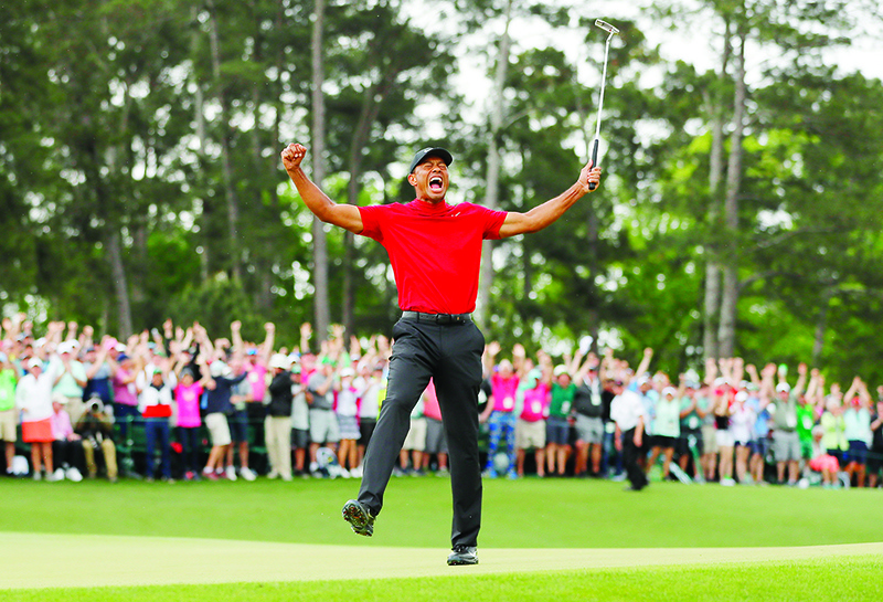 AUGUSTA: File photo shows Tiger Woods of the United States celebrates after sinking his putt on the 18th green to win during the final round of the Masters at Augusta National Golf Club on April 14, 2019 in Augusta, Georgia.  — AFP