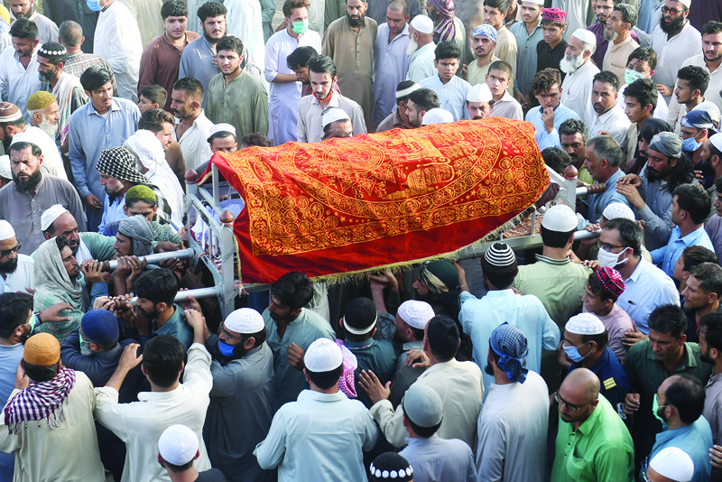 Mourners carry the coffin of a private security guard, killed in a gunmen attack at the Pakistan Stock Exchange building, during his funeral in Karachi on June 29, 2020. - Baloch separatists opened fire and hurled a grenade at the Pakistan Stock Exchange in Karachi on June 29, authorities said, killing four people including a policeman. Three security guards were killed in the melee, while local police chief Ghulam Nabi Memon said all four assailants were shot dead. (Photo by Asif HASSAN / AFP)