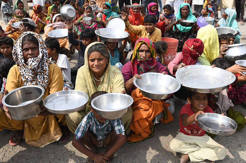 MAHARASTRA:  Migrant labourers and their family members from Maharastra hold kitchen utensils as they protest against the government for the lack of food in a slum area. — AFP
