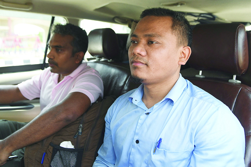 Indian High Commission officials Dwimu Brahms (right) and Selvadhas Paul sit in a car after their release from the Pakistan authorities for the accusation of been involved in a hit-and-run incident, as they return to India at the India Pakistan Wagah Border Post about 35 km from Amritsar. — AFP