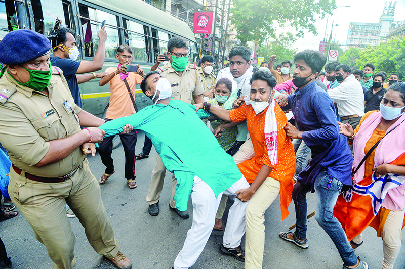 SILIGURI: Police personnel catch activists of Bharatiya Janata Party (BJP) as they shout slogans during an anti-China protest in Siliguri. — AFP