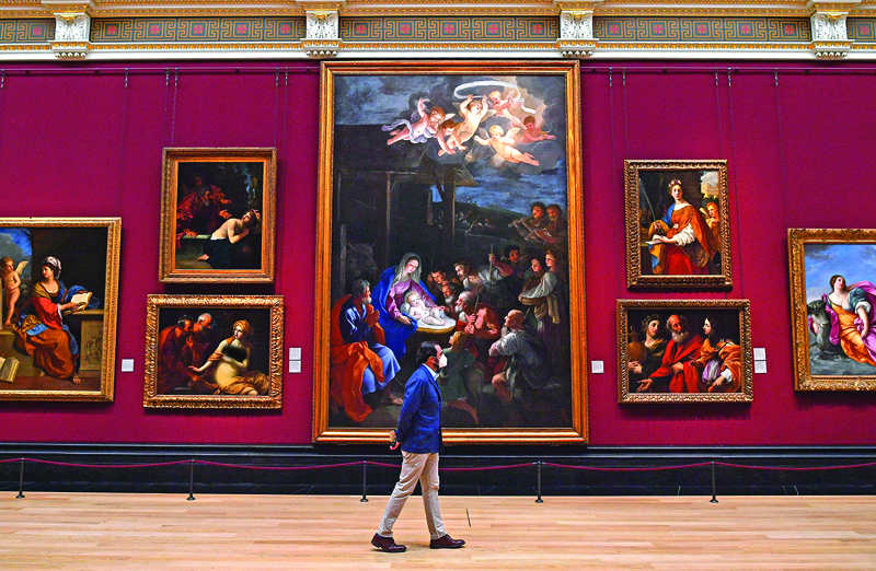 A member of staff wearing a protective face mask patrols a room inside the National Gallery on July 4, 2020, as the gallery prepares to reopen on July 8 following the easing of restrictions imposed during the novel coronavirus COVID-19 pandemic. - English art galleries, museums and cinemas are able to open their doors from Saturday, July 4, as relaxations of the coronavirus restrictions continue. (Photo by JUSTIN TALLIS / AFP) / RESTRICTED TO EDITORIAL USE - MANDATORY MENTION OF THE ARTIST UPON PUBLICATION - TO ILLUSTRATE THE EVENT AS SPECIFIED IN THE CAPTION