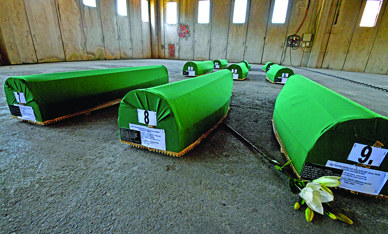 SREBRENICA: Photo shows caskets with the remains of 9 newly identified victims of the 1995 massacre in Srebrenica in a deserted factory. — AFP