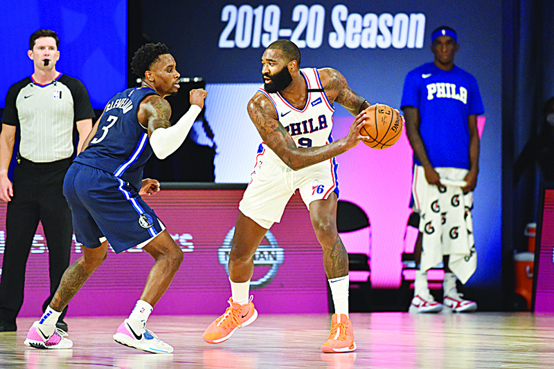Orlando, FL - JULY 28: Kyle O'Quinn #9 of the Philadelphia 76ers handles the ball against the Dallas Mavericks during a scrimmage on July 28, 2020 at HP Field House at ESPN Wide World of Sports in Orlando, Florida. NOTE TO USER: User expressly acknowledges and agrees that, by downloading and/or using this Photograph, user is consenting to the terms and conditions of the Getty Images License Agreement. Mandatory Copyright Notice: Copyright 2020 NBAE   Jesse D. Garrabrant/NBAE via Getty Images/AFP