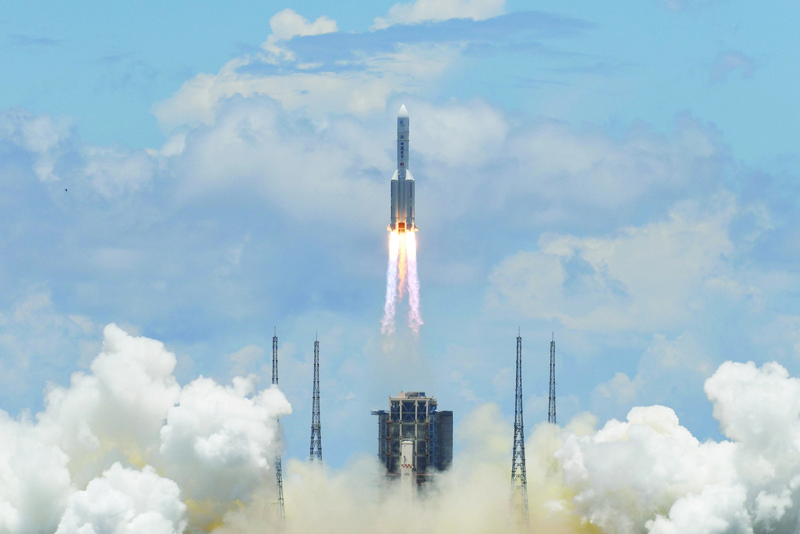 TOPSHOT - A Long March-5 rocket, carrying an orbiter, lander and rover as part of the Tianwen-1 mission to Mars, lifts off from the Wenchang Space Launch Centre in southern China's Hainan Province on July 23, 2020. (Photo by Noel CELIS / AFP)