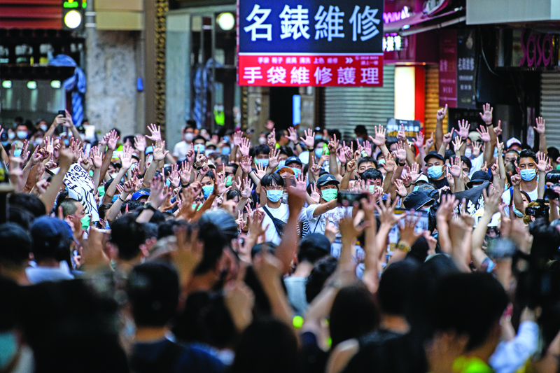 Protesters chant slogans and gesture during a rally against a new national security law in Hong Kong on July 1, 2020, on the 23rd anniversary of the city's handover from Britain to China. - Hong Kong police arrested more than 300 people on July 1 -- including nine under China's new national security law -- as thousands defied a ban on protests on the anniversary of the city's handover to China. (Photo by Anthony WALLACE / AFP)