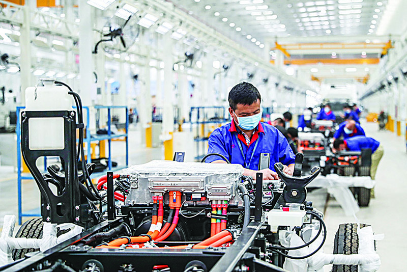 HUAIAN: This file photo shows an employee working on a new energy vehicle assembly line at a BYD factory in Huaian in China’s eastern Jiangsu province. —AFP