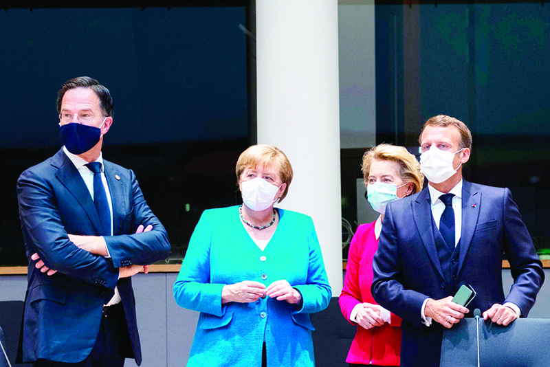 BRUSSELS: Netherlands’ Prime Minister Mark Rutte (left) looks on next to Germany’s Chancellor Angela Merkel (2nd left), President of the European Commission Ursula von der Leyen (2nd right) and France’s President Emmanuel Macron prior the start of the European Council building in Brussels. — AFP
