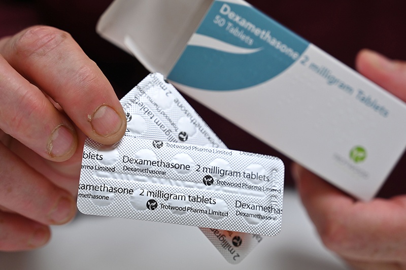 LONDON: In this photo taken on June 16, 2020, a pharmacist holds a box of dexamethasone tablets at a pharmacy. — AFP