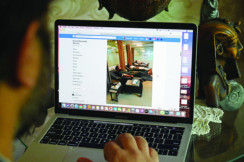 LAHORE: This photo taken on June 28, 2020 shows Zoraiz Riaz Syed using his laptop as he runs the Facebook group “Corona Recovered Warriors” consisting of former COVID-19 patients at his home. —  AFP