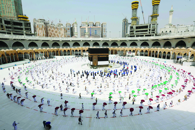 A picture taken on July 29, 2020 shows pilgrims circumambulating around the Kaaba, Islam's holiest shrine, at the centre of the Grand Mosque in the holy city of Mecca, ahead of the annual Muslim Hajj pilgrimage. - Mask-clad Muslim pilgrims began the annual hajj, dramatically downsized this year as the Saudi hosts strive to prevent a coronavirus outbreak during the five-day pilgrimage. The hajj, one of the five pillars of Islam and a must for able-bodied Muslims at least once in their lifetime, is usually one of the world's largest religious gatherings. (Photo by STR / AFP)
