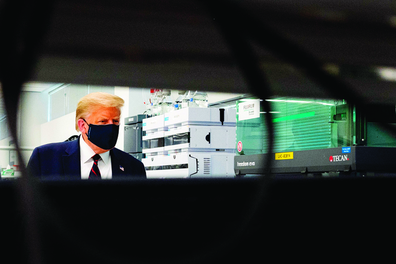 MORRISVILLE, North Carolina: US President Donald Trump wears a mask as he tours a lab making components for a potential vaccine on Monday. - AFP