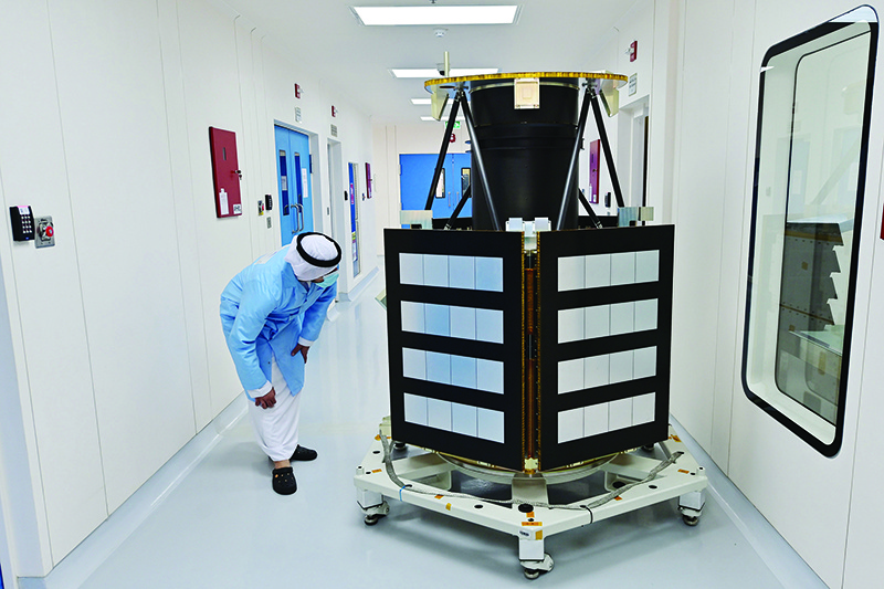 DUBAI: An engineer observes a KhalifaSat model at the Mohammed bin Rashid Space Centre on July 5, 2020. — AFP
