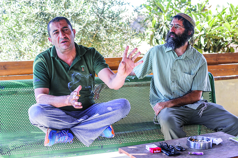 Khaled Abu Awad (left), a Palestinian from Bethlehem, and Shaul Judelman, an Israeli settler from nearby Teqoa settlement, who are both co-directors of movement of settlers and Palestinians called ‘Shorashim-Judur’ (Hebrew and Arabic for ‘Roots’) and who both published a petition against Israel’s intention to annex parts of the occupied West Bank, speak during an interview. — AFP