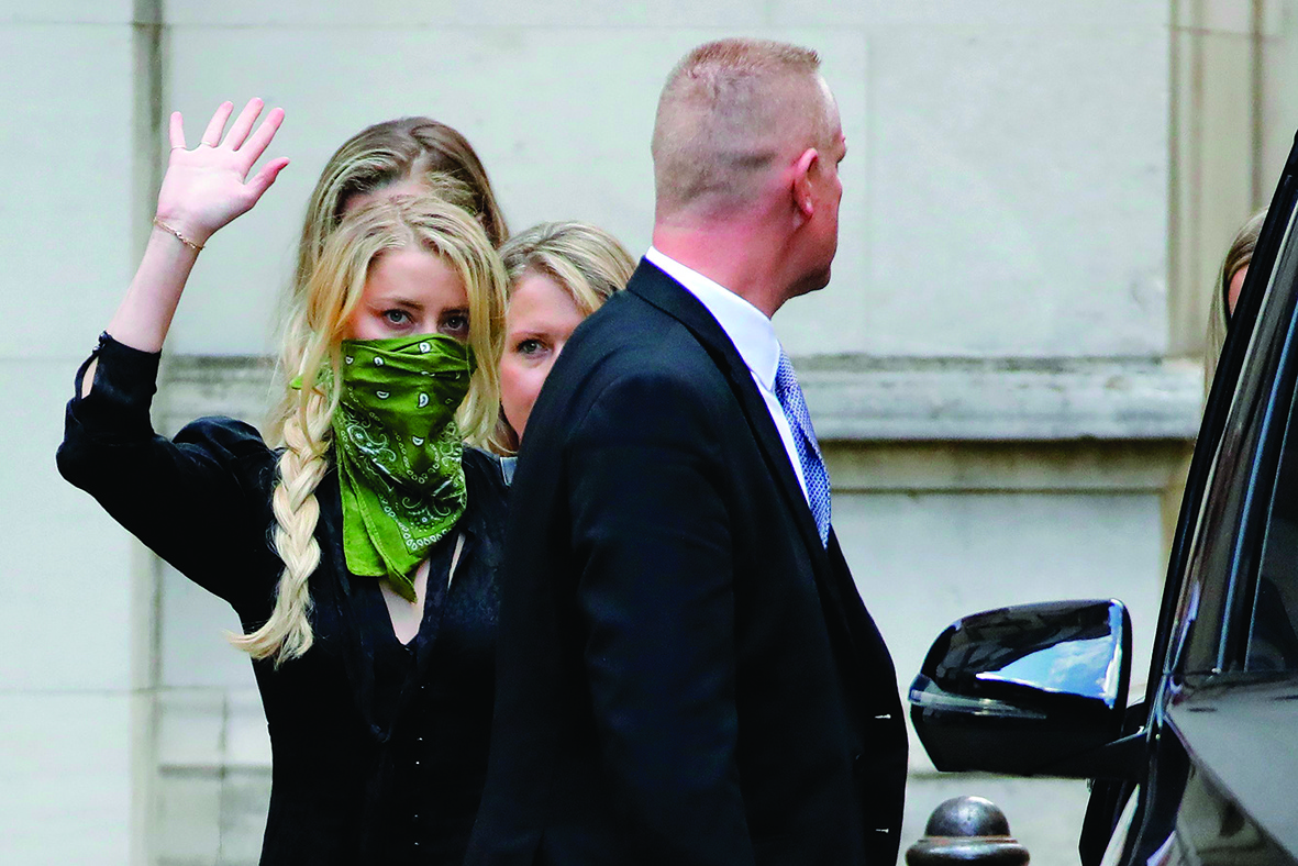 US actress Amber Heard (L) leaves on the fourth day of the libel trial by her former husband US actor Johnny Depp against News Group Newspapers (NGN), at the High Court in London, on July 10, 2020. - The blockbuster lawsuit against the publisher News Group Newspapers (NGN) and executive editor Dan Wootton, who wrote the article, is designed to clear Depp's name. (Photo by Tolga AKMEN / AFP)