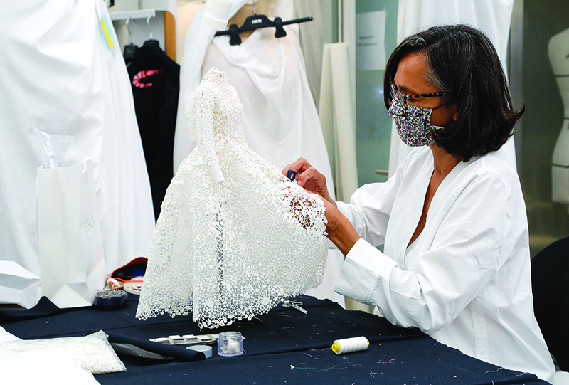 An employee sews a miniature dress for the recording of Dior Haute Couture collection’s presentation movie, in Dior’s sewing workshop in Paris.